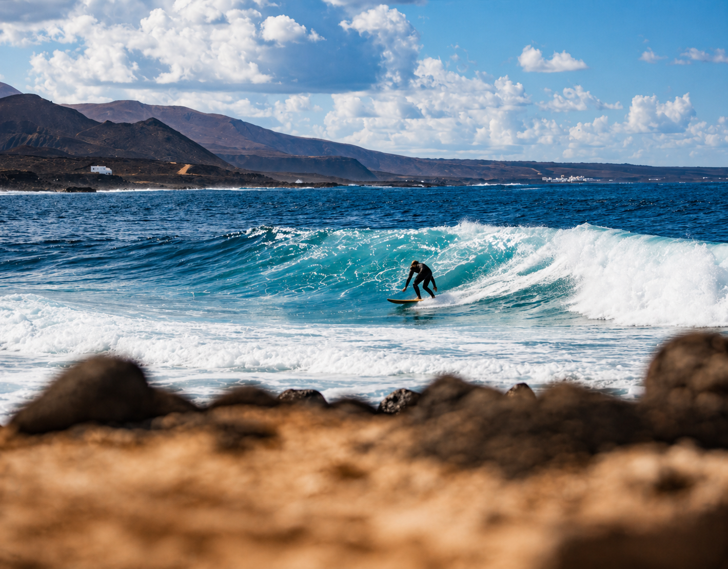 Surfer riding a wave at Famara beach, Lanzarote